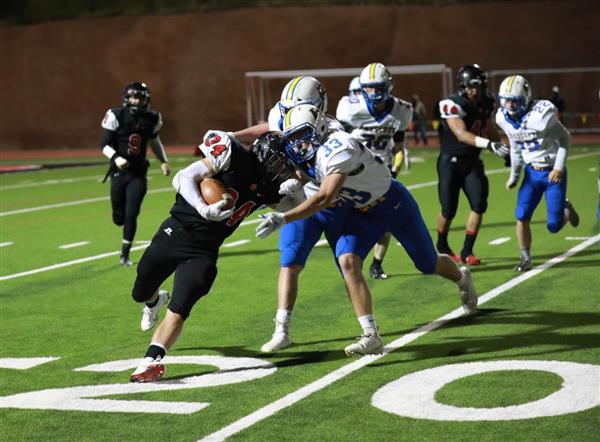  Coconino football player collides with two defenders. 