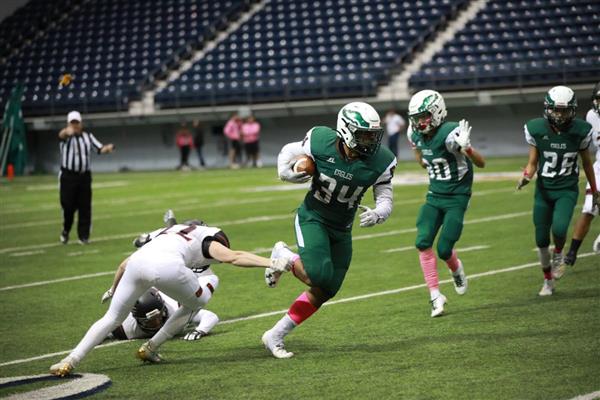  Flagstaff football player evades a defender. 
