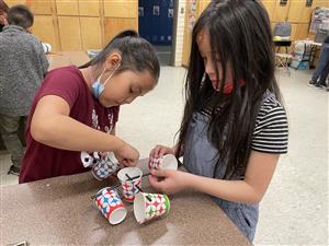 two students working together to create an anemometer