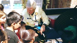 Search and Rescue gentleman showing students equipment in one of the vehicles