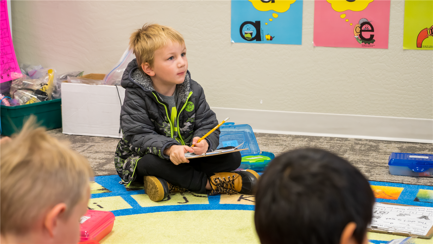 Teacher works with a student at a desk. Teacher works with a student at a desk.