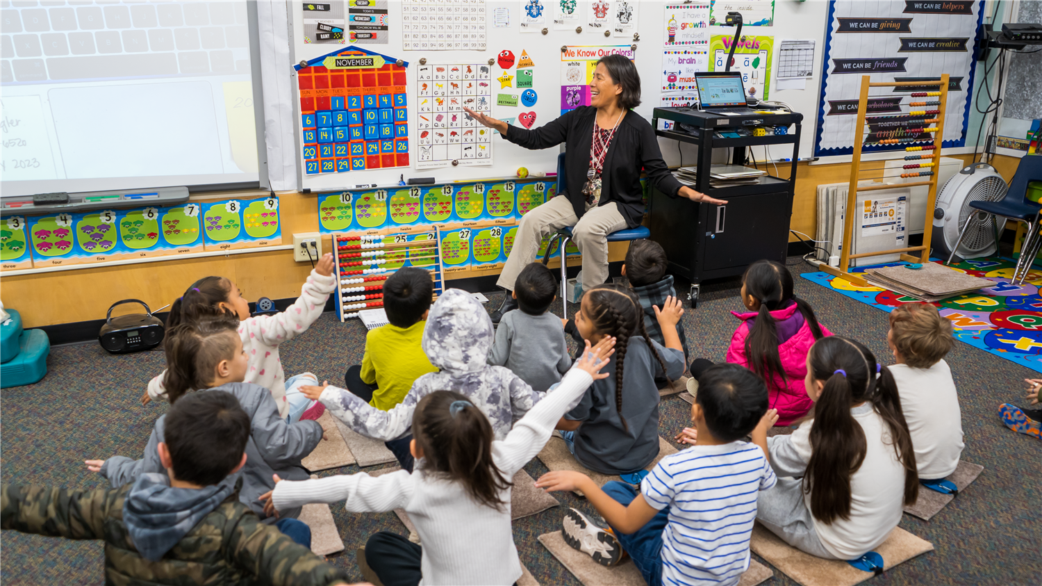 Students learning sounds with teacher. Students learning sounds with teacher.