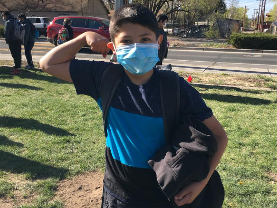 students shows off his muscles after winning a sit-up competition